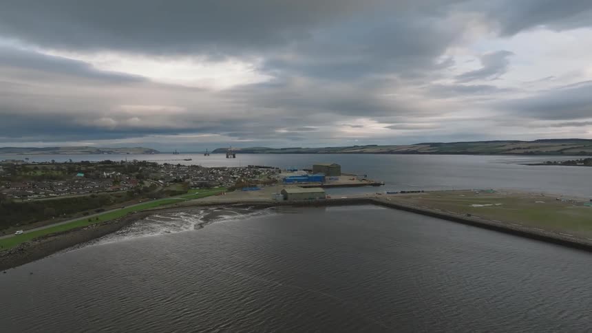 Urban city in the background surrounded by the sea on a cloudy day