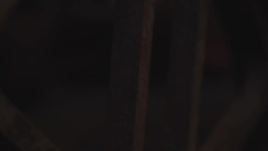 Wooden wheel inside a stable