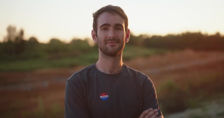 Man in a field with his arms crossed