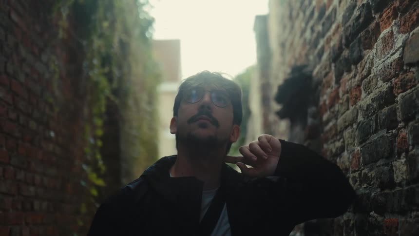 Thoughtful man stands amidst the ruins