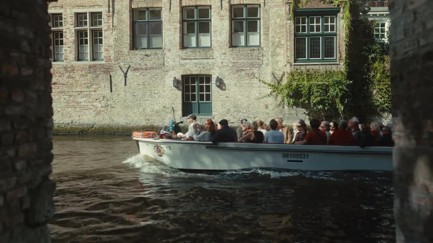 A view of a boat in a city with canals