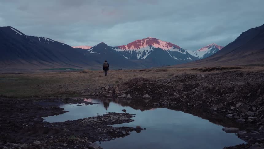 Person walking alone in a snowy mountainous area