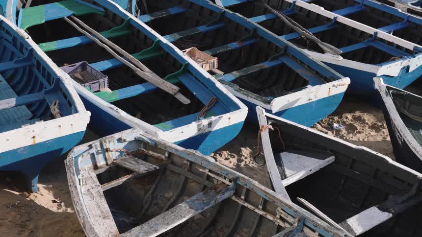 Small boats are sitting in the sand