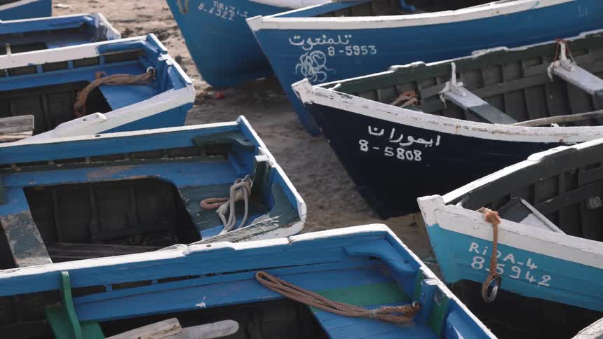 Wooden boats moored on the sand