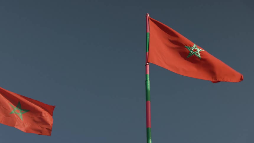 Moroccan flag against a blue sky