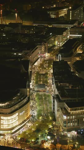 Many people are walking in the city at night