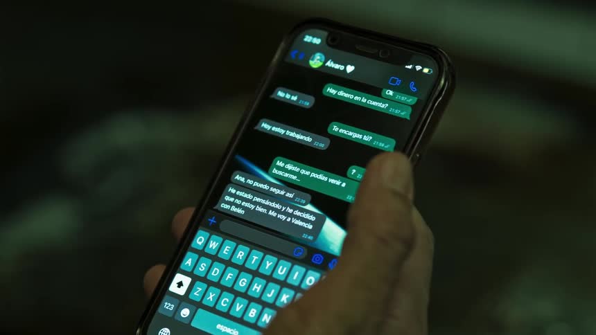 Person holds a smartphone open to a text messaging app