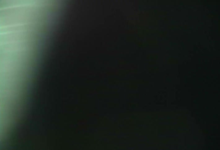 An incredibly shaky view of a landscape out the window of a moving vehicle