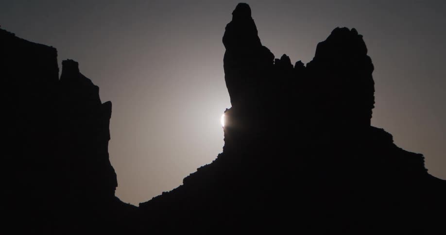 Rock formation on a mountain as moonlight glows in the distance