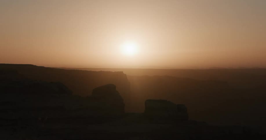 A view of the sun setting over the desert