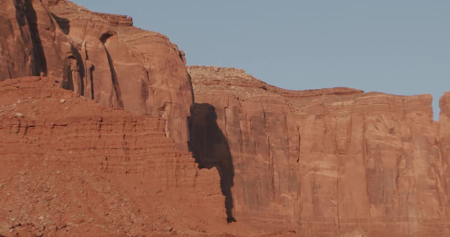 Sandstone rock formation with vertical cliffs in a desert landscape