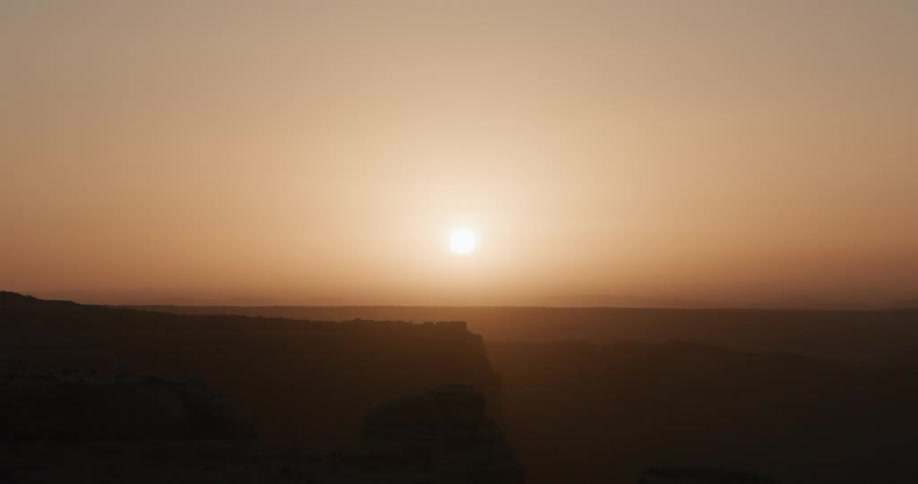 A view of the sun setting over a landscape