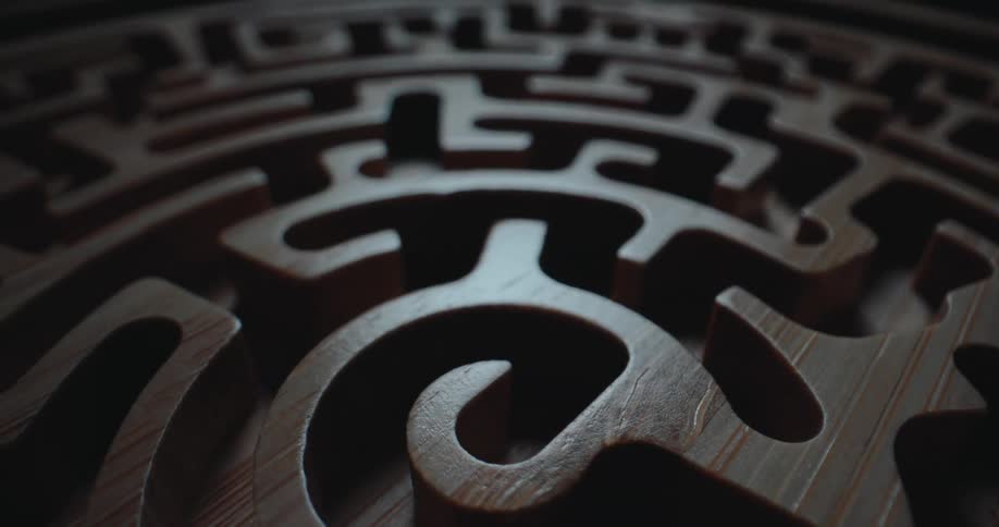Wooden maze structure with curved cutouts and varying depth