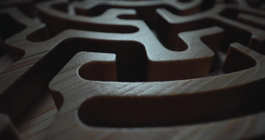 A close up of a carved wooden maze