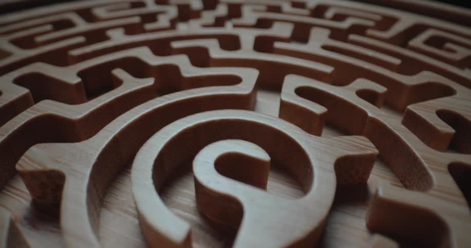 Smooth blonde walls form a maze on a small circular surface