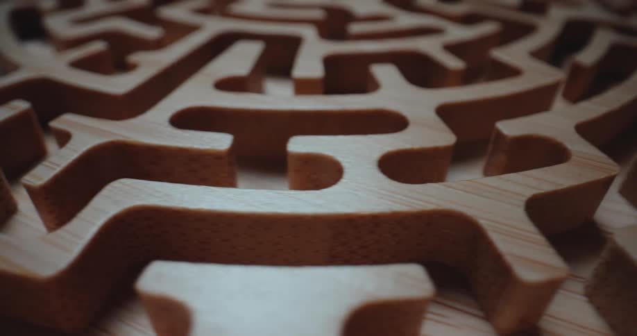 Detail of a wooden maze with sinuous channels and defined edges