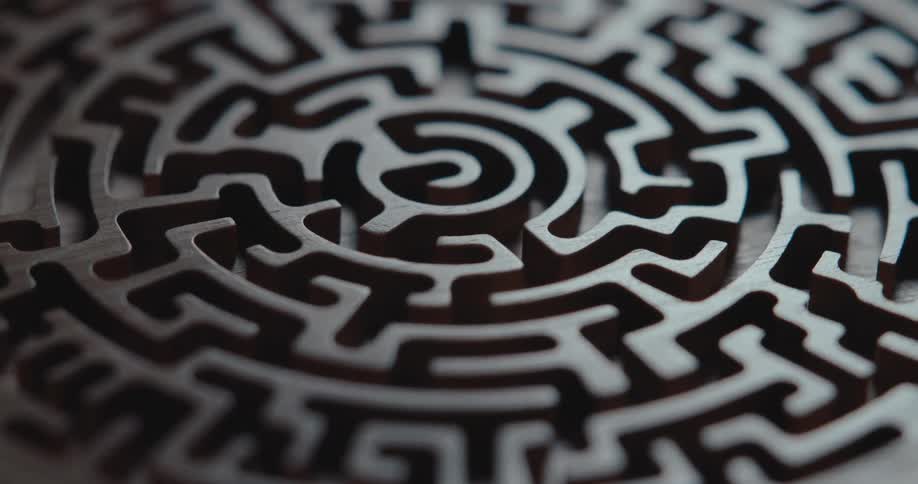 A maze is carved into the surface of a smooth piece of wood
