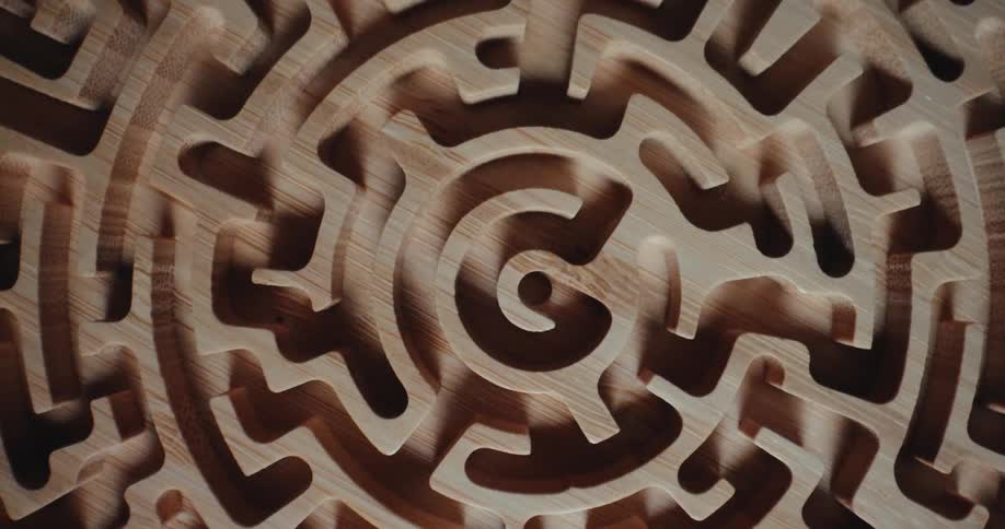 A wooden maze spins in a hypnotic circle its paths twisting inward