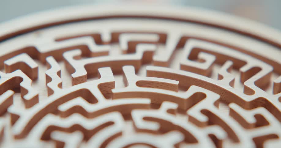 Light shines on a three dimensional labyrinth carved on a round disk as it turns and then it is dark