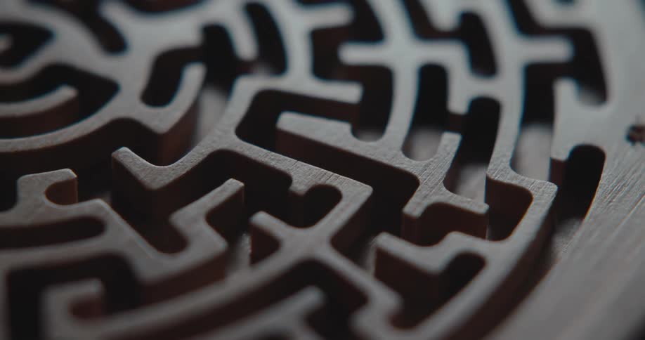 Detail of a circular wooden maze with narrow channels and precise cutouts