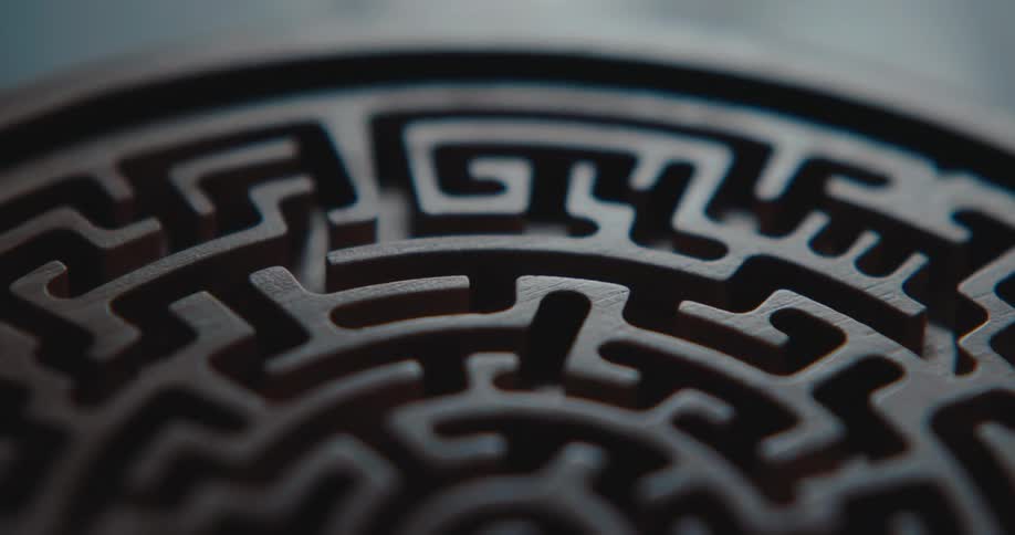 Circular wooden maze with a spiral pattern and interconnected channels