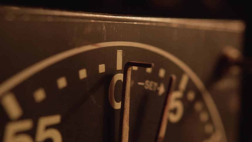Metal marker on a circular dial with numbering and a prominent pointer