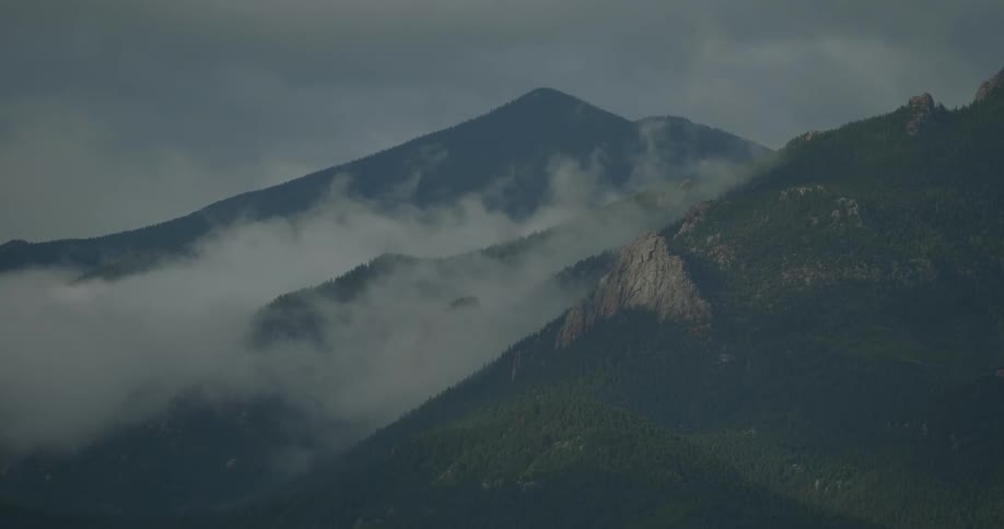 A view of a mountain range with clouds