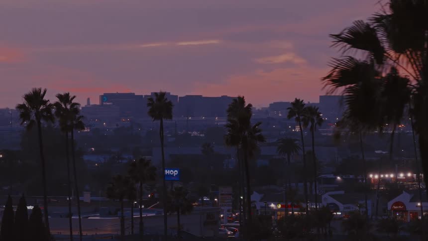 The city is covered with fog at sunset