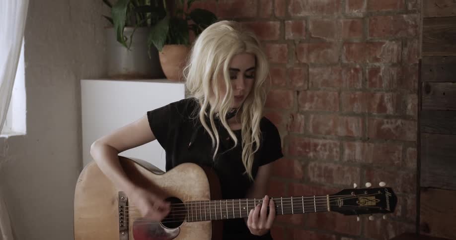 A woman is playing the guitar