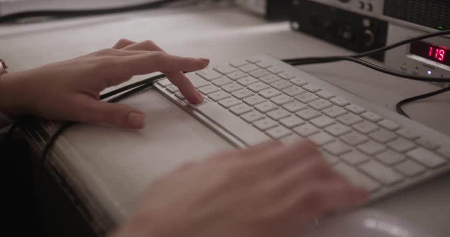 A person holds down buttons on a keyboard