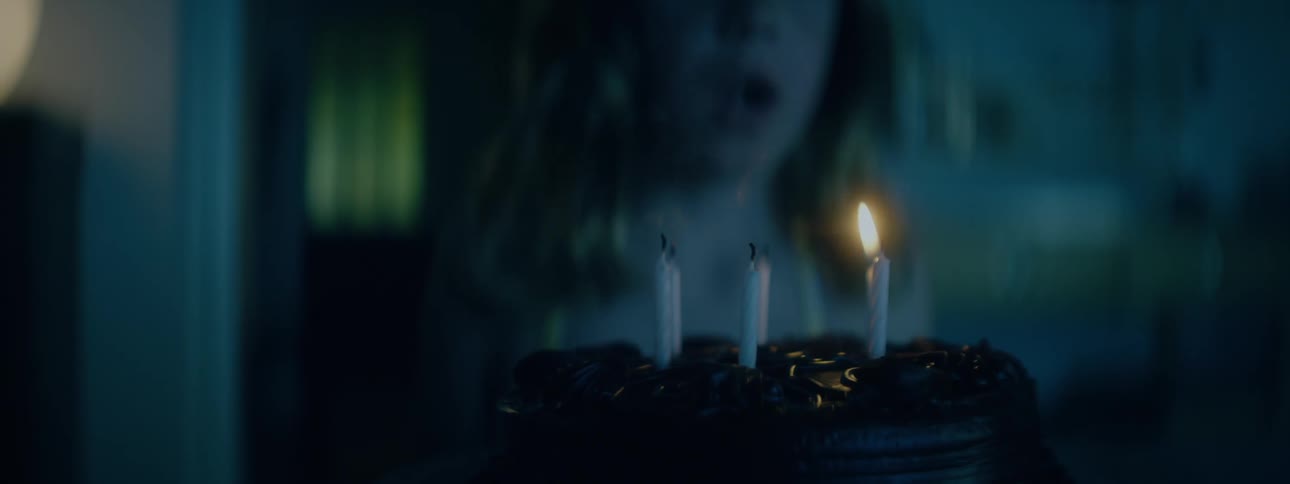 Girl blowing out the candles on a birthday cake