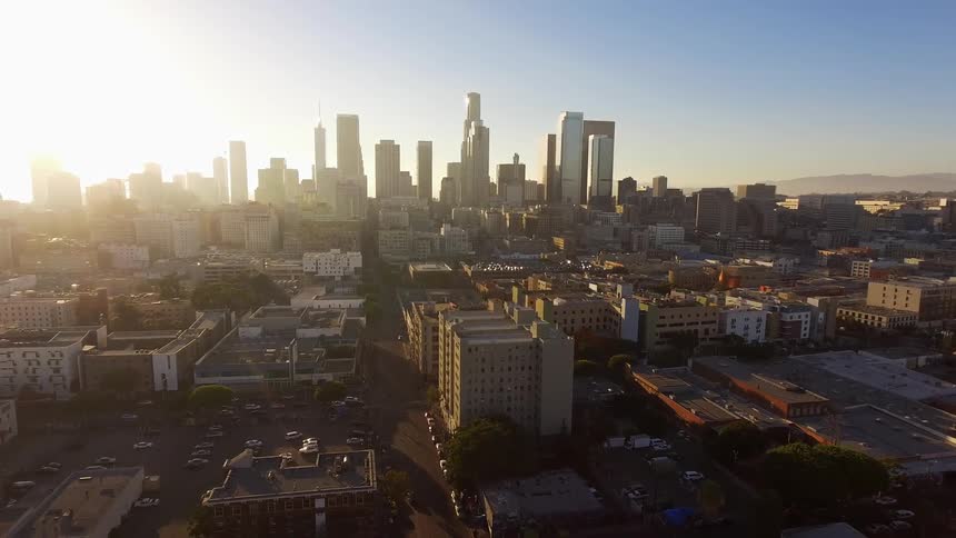 Sun setting behind downtown Los Angeles skyline