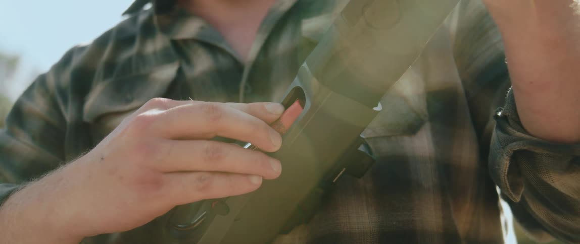 Person loading a rifle