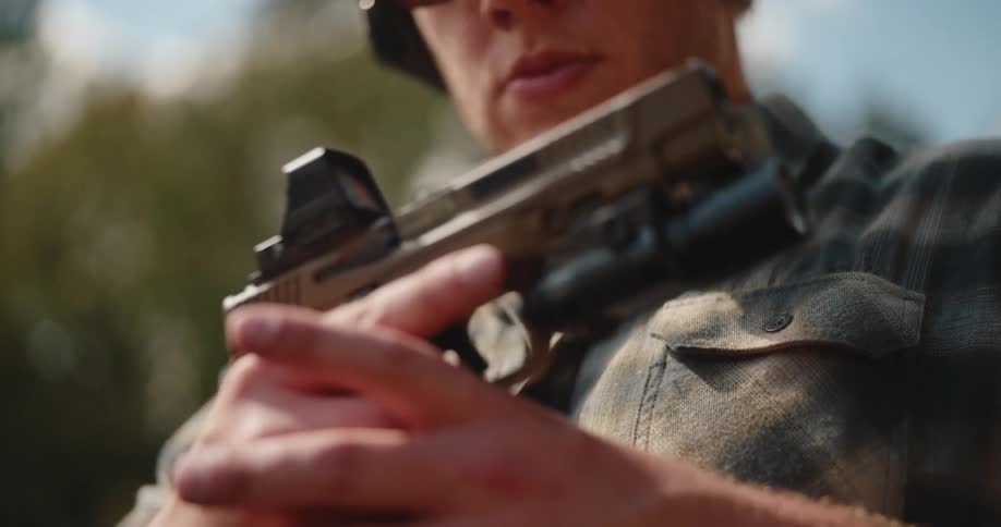 A man inspects a gun