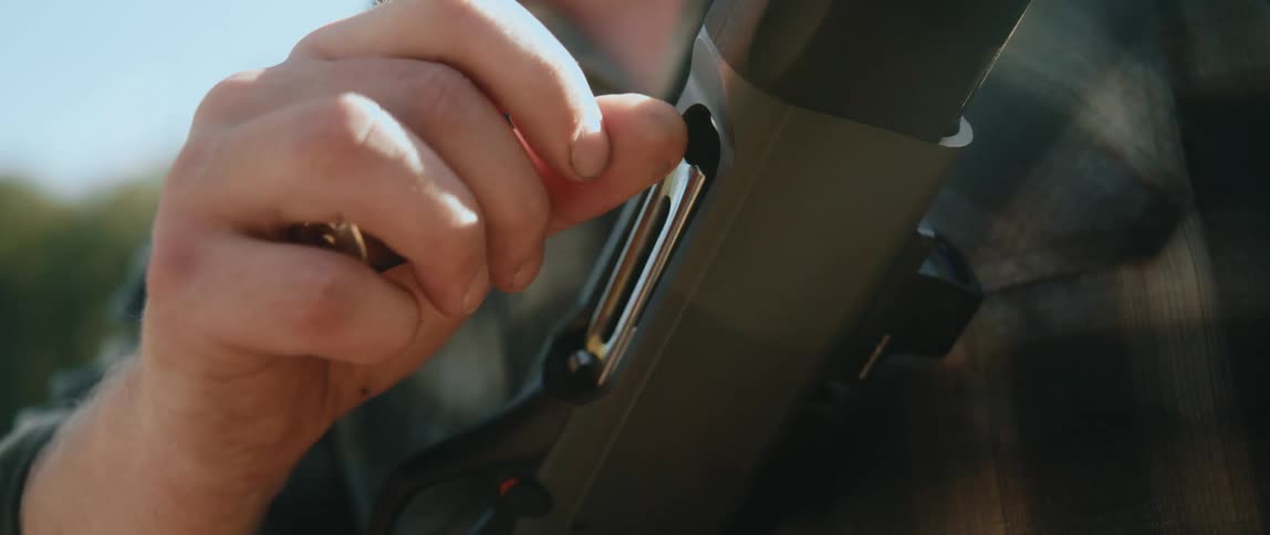 A man loads a gun with blanks