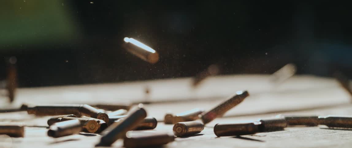 Bullet casings fall onto a table