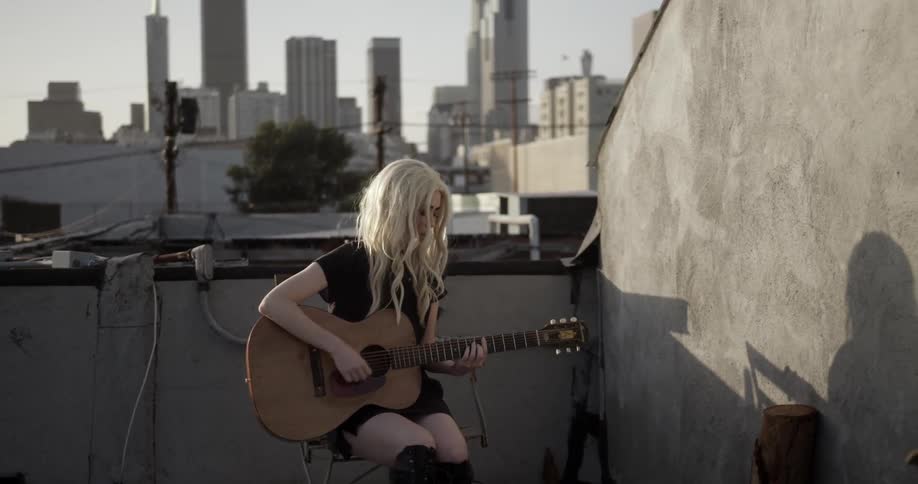 A woman is playing the guitar