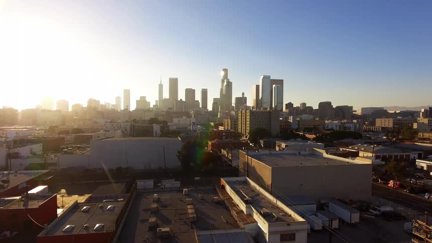 The sun is rising above Los Angeles