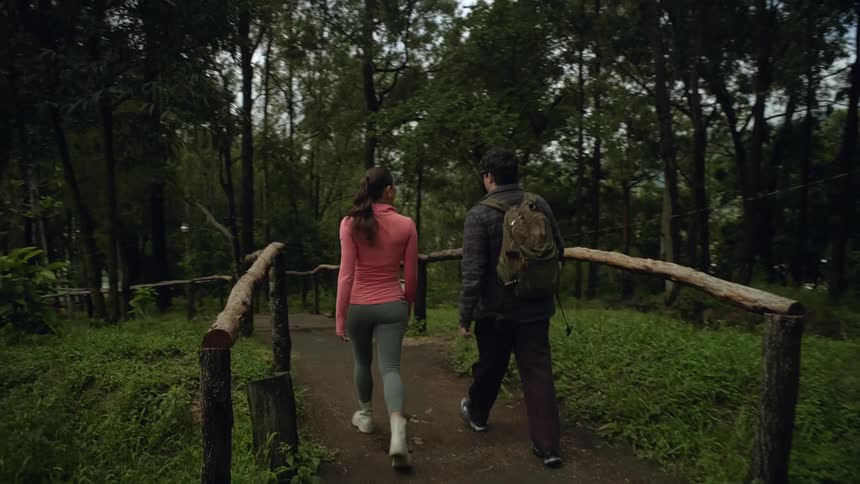 A boy and girl walk along a trail