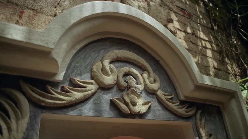 There is an arch and design above the doorway