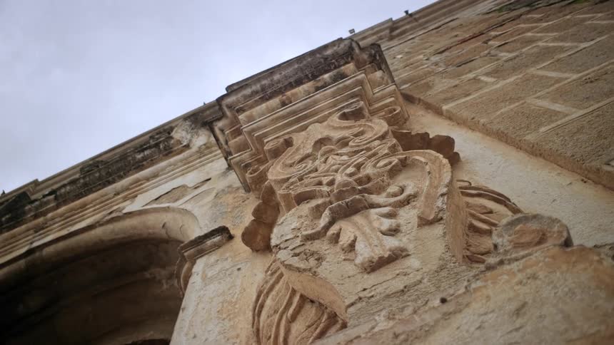 Carved stone architectural detail viewed from below on a historic faade