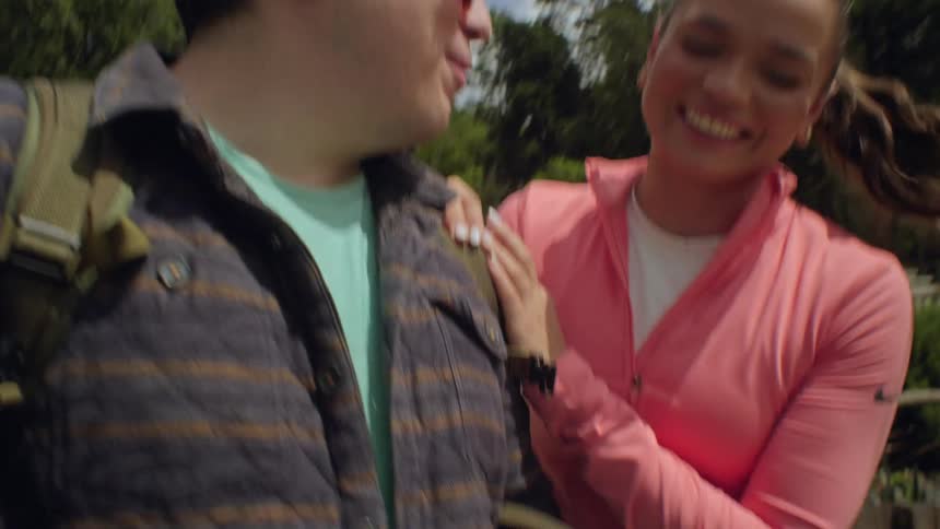 A man and woman playing with a phone