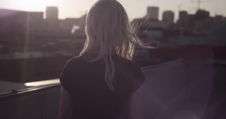 A woman walks on a roof top