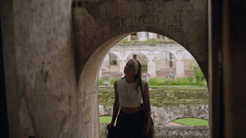 A girl walks under an archway