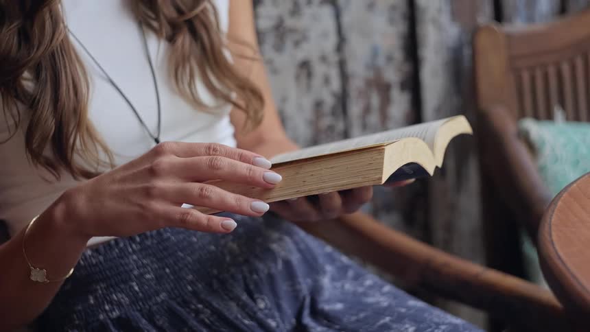 A woman sits and reads a book