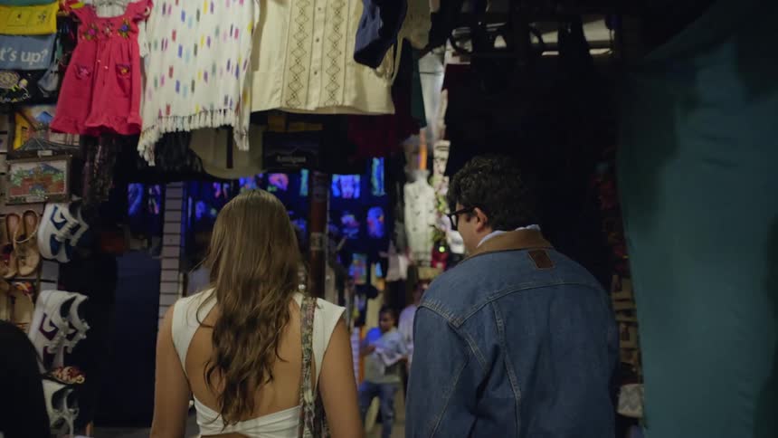 The couple walk through the market