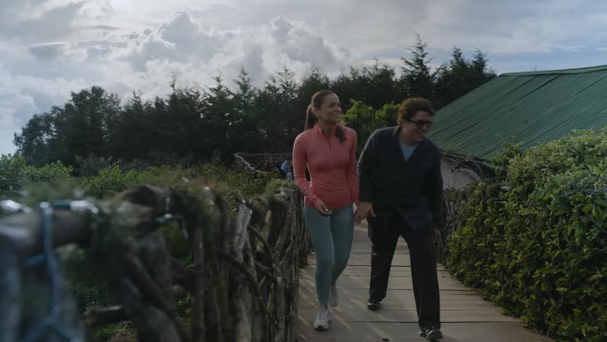 A man and woman walking outdoors