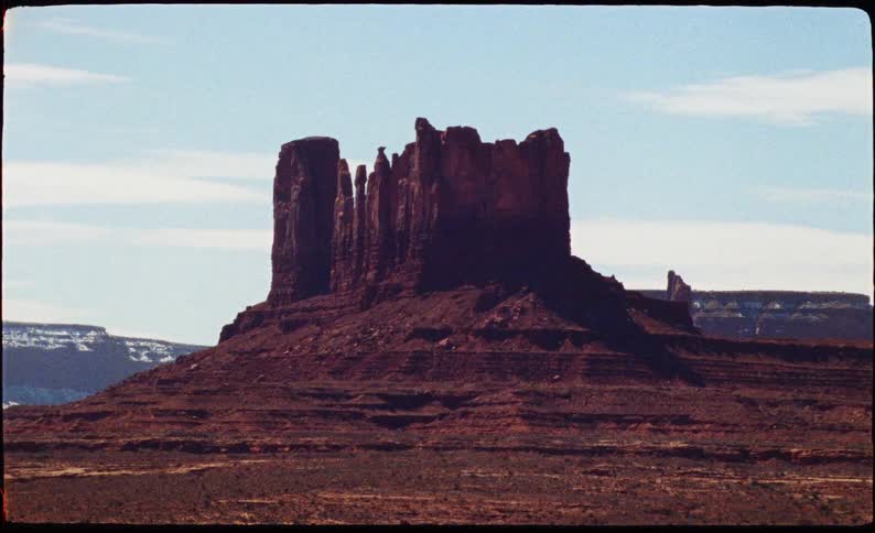 This is the primary boundary in the background where the flat desert floor and distant mesas meet the pale blue sky it creates a clear sense of scale and vastness for the environment