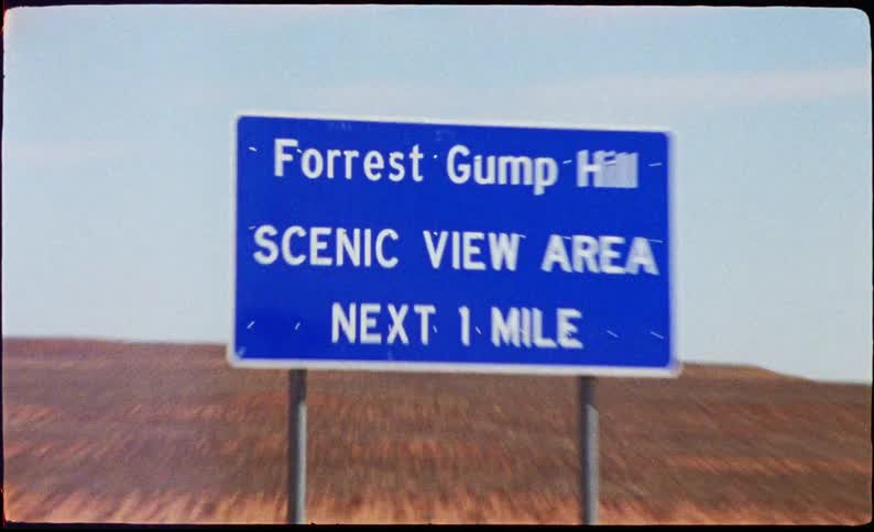 A road sign is by the desert