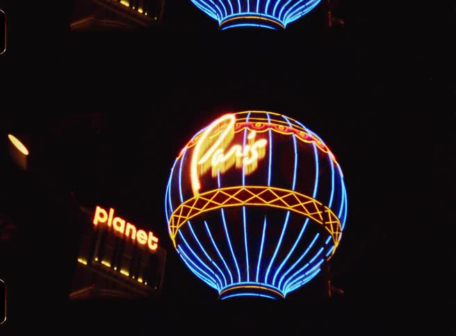 A large sign in the shape of an orb is lit up outside the casino